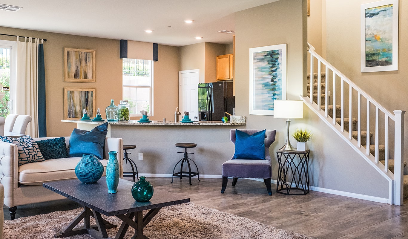 A well designed lounge area with grey sofa and blue throw pillows