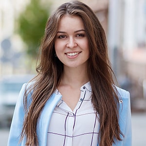 a beautifulwoman in a blue blazer with long brown hair