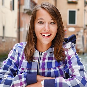 a young smiling lady wearing a checked cardigan